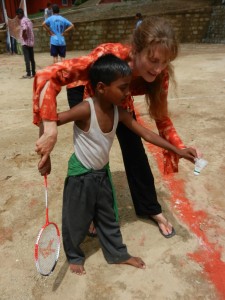 Sports equipment arrives:  Future badminton champion receives a few tips in his very first game.